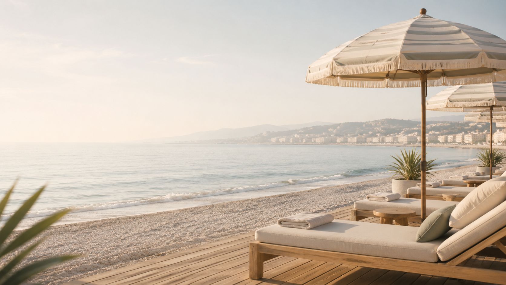 Hotel Amour Plage sunbeds and umbrellas beside the sea in Nice